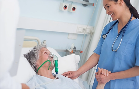Nurse assisting patient with oxygen mask